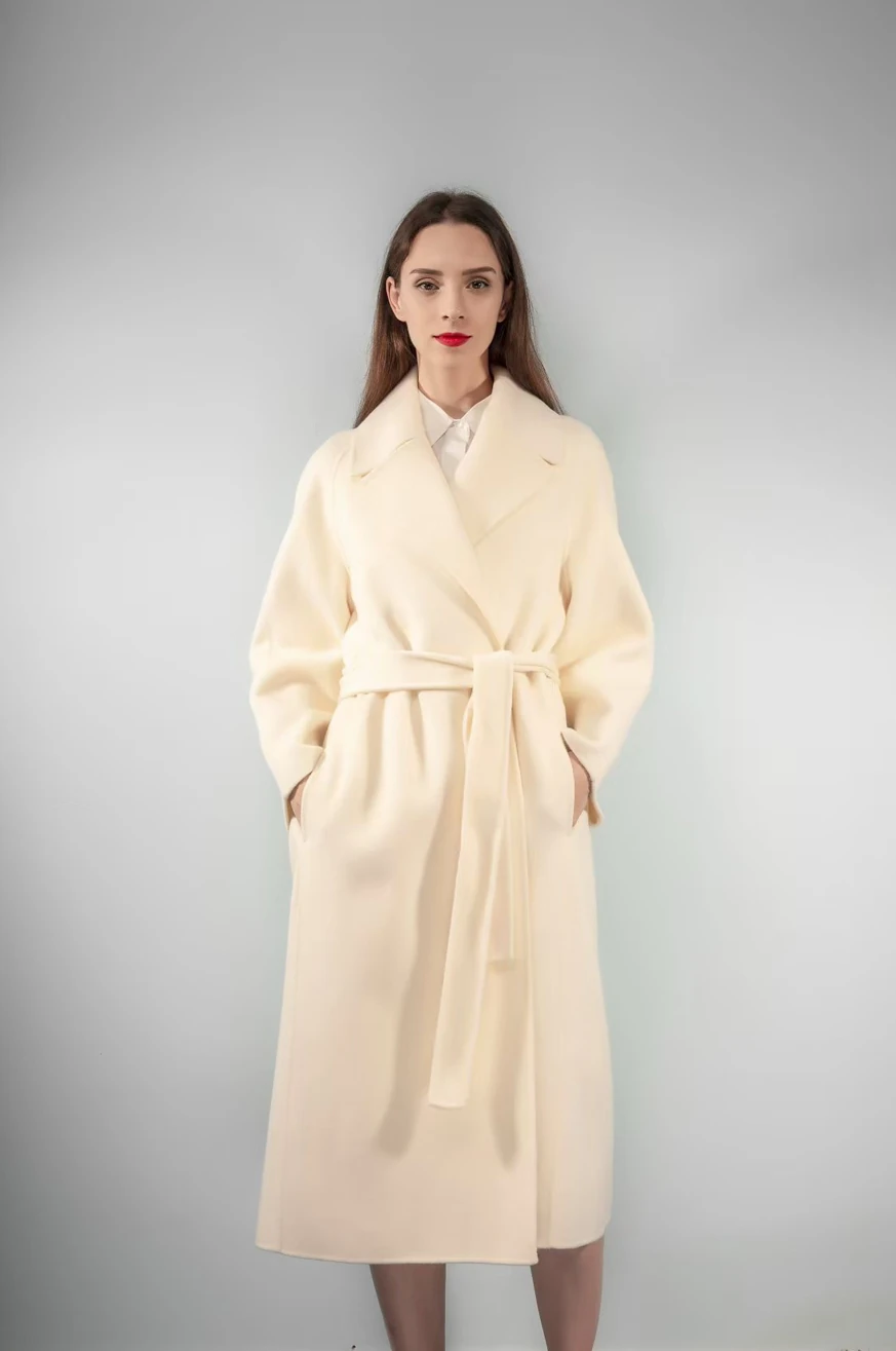 Ivory belted wrap coat with a broad lapel